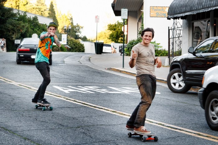 Skateboarders thru the middle of town