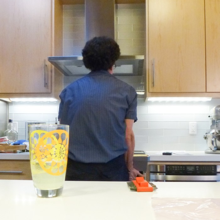 The repairman lifting the ailing oven back into place