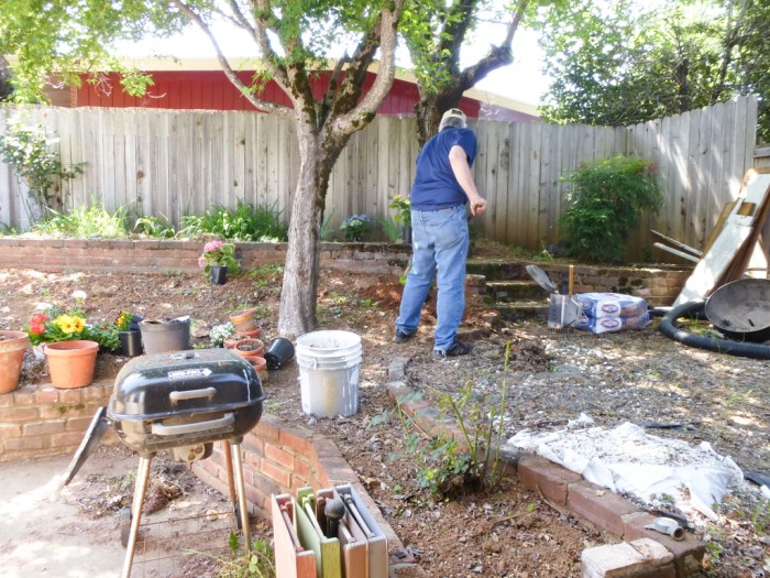 hubby digging holes in the very rocky, hard soil