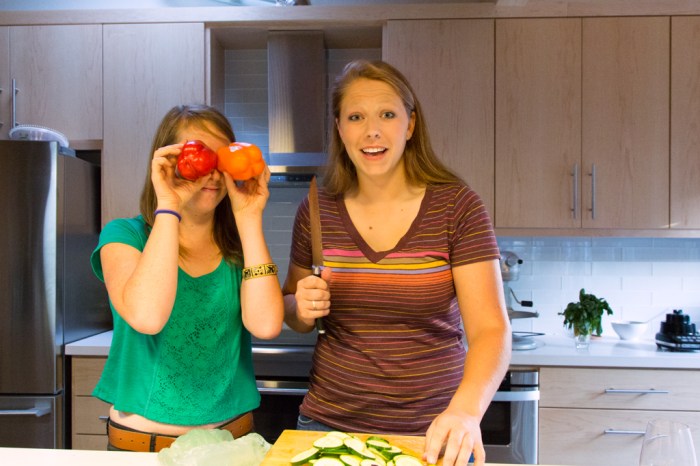 Daughter (pepper eyes) with good friend making salad